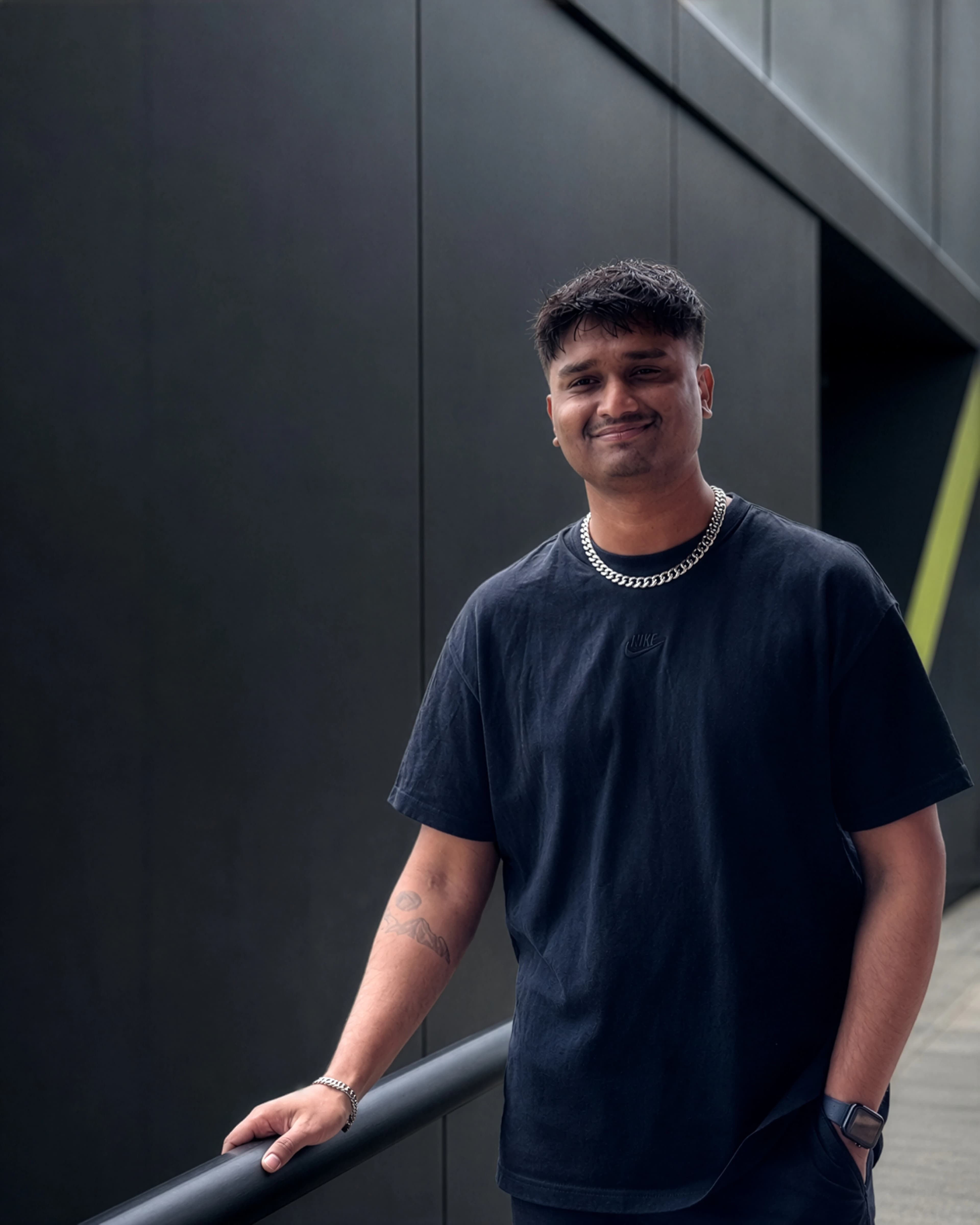 Fahmid Uddin in front of a dark architectural facade